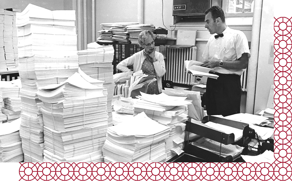 Faculty with large stacks of case studies on paper